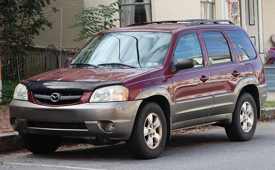 2003 Mazda Tribute LX V6 in Merlot Pearl Metallic, front left, 09-19-2026