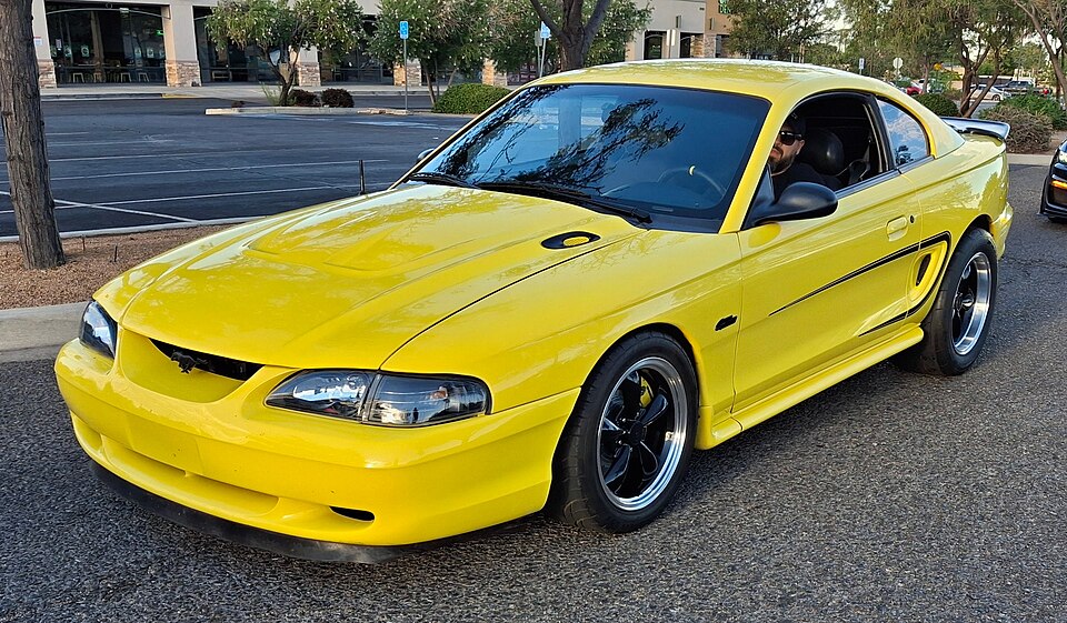 1998 Ford Mustang, yellow, front left side, 2026 Hot Wheels Legends Tour - Albuquerque, NM 2026-08-22