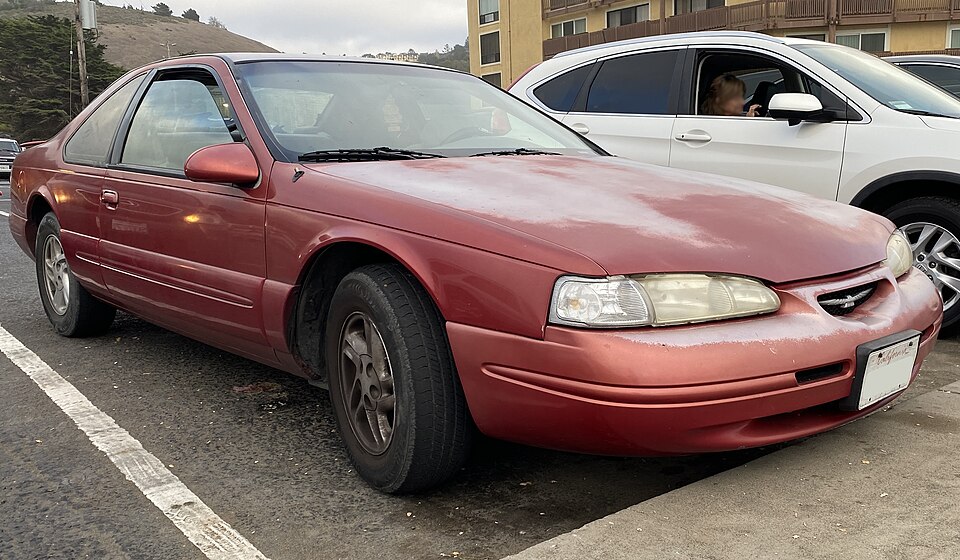 1997 Ford Thunderbird LX in Laser Red Metallic, front right, 08-14-2022