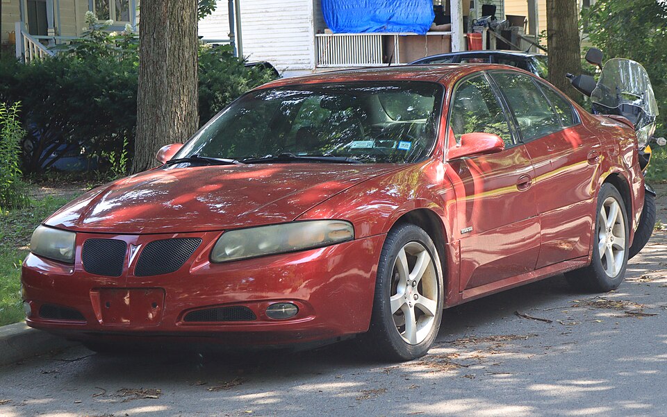2004 Pontiac Bonneville GXP in Crimson Red, front left, 07-11-2026