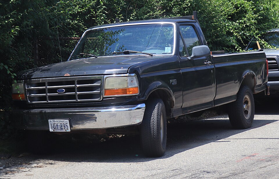 1995 Ford F-150 XL in Black, front left, 07-04-2026