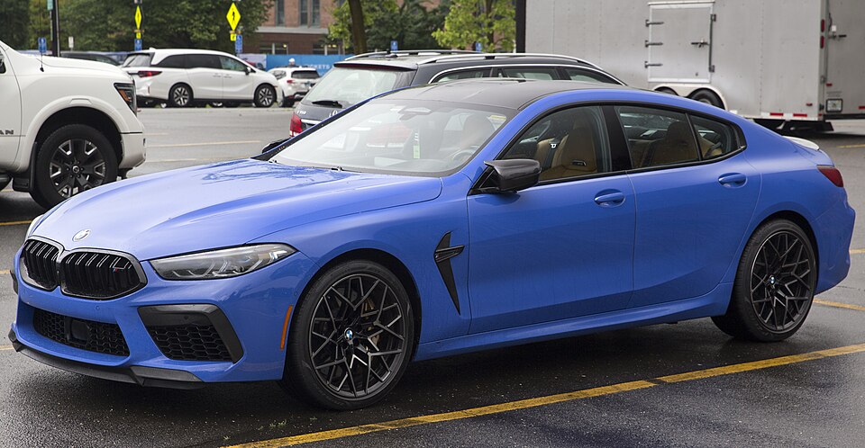 2025 BMW M8 Competition Gran Coupé in Marina Bay Blue Metallic, front left