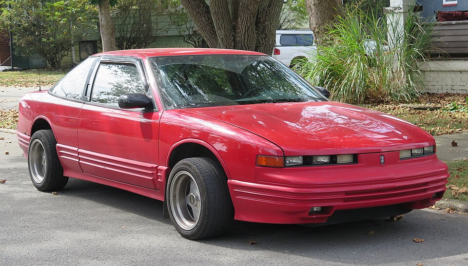 1996 Oldsmobile Cutlass Supreme coupe in Bright Red, front right, 09-20-2025