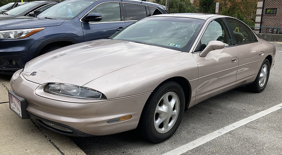 1998 Oldsmobile Aurora in Champagne Metallic, front left, 10-7-2021