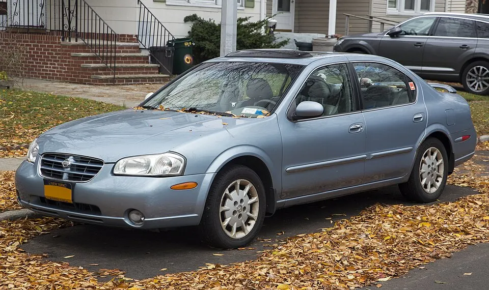 2000 Nissan Maxima GXE in Satin Blue Pearl Titanium Metallic, front left, photographed in United States