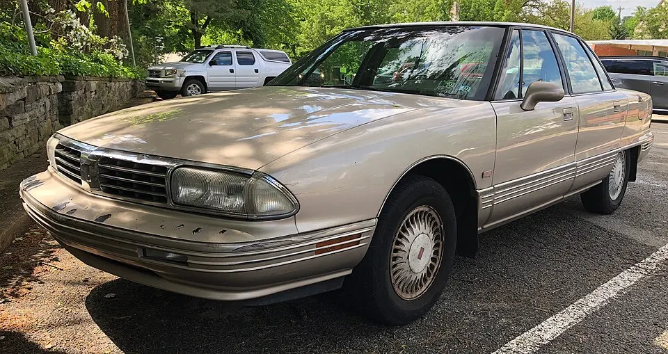 1995 Oldsmobile Ninety Eight Regency Elite Series I in Beige Metallic, front left, 05-16-2022, photographed in United States