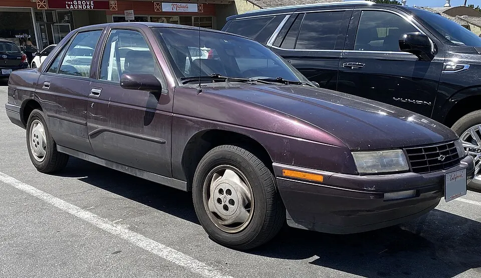 1996 Chevrolet Corsica Base in Black Rose Metallic, front right, 08-13-2022, photographed in United States
