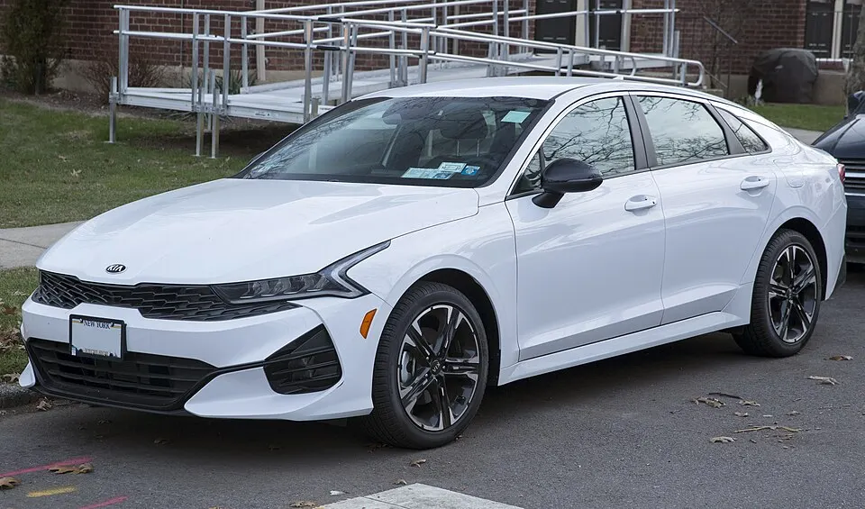 2021 Kia K5 GT-Line in Glacial White Pearl, front left, photographed in United States