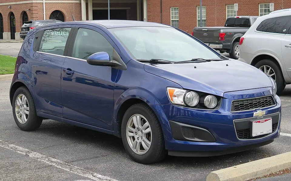 2013 Chevrolet Sonic LT hatchback in Blue Topaz Metallic, front right, 04-26-2025, photographed in United States