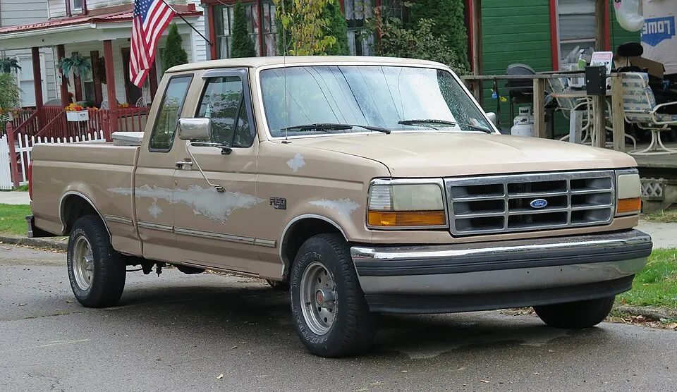 1996 Ford F-150 XLT in Light Saddle Clearcoat Metallic, front right, 10-12-2025, photographed in United States