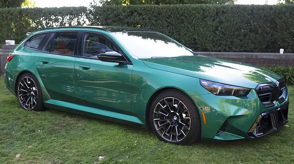 2025 BMW M5 Touring in Isle of Man Green, front right, photographed in United States