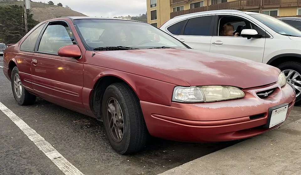 1997 Ford Thunderbird LX in Laser Red Metallic, front right, 08-14-2022, photographed in United States