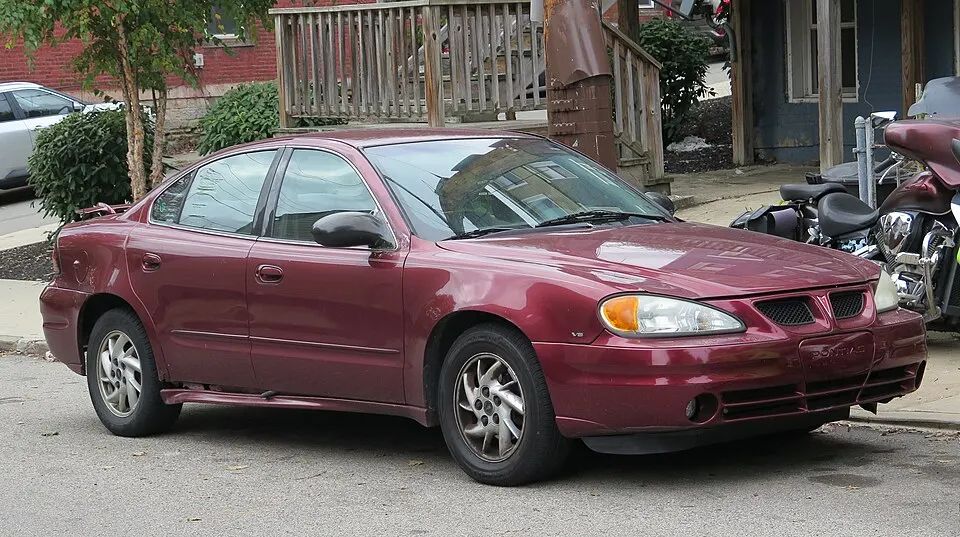 2003 Pontiac Grand Am SE1 in Redfire Metallic, front right, 10-25-2025, photographed in United States