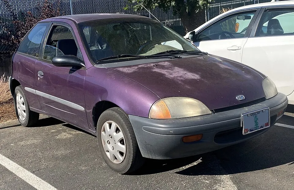 1997 Geo Metro LSi in Super Grape Metallic, front right, 07-26-2023, photographed in United States