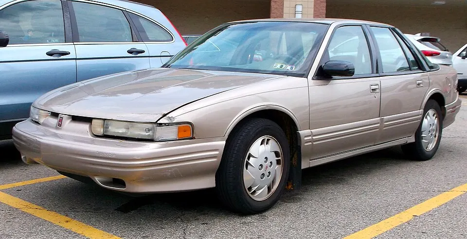 1997 Oldsmobile Cutlass Supreme SL in Light Sandrift Metallic, front left, 07-24-2022, photographed in United States
