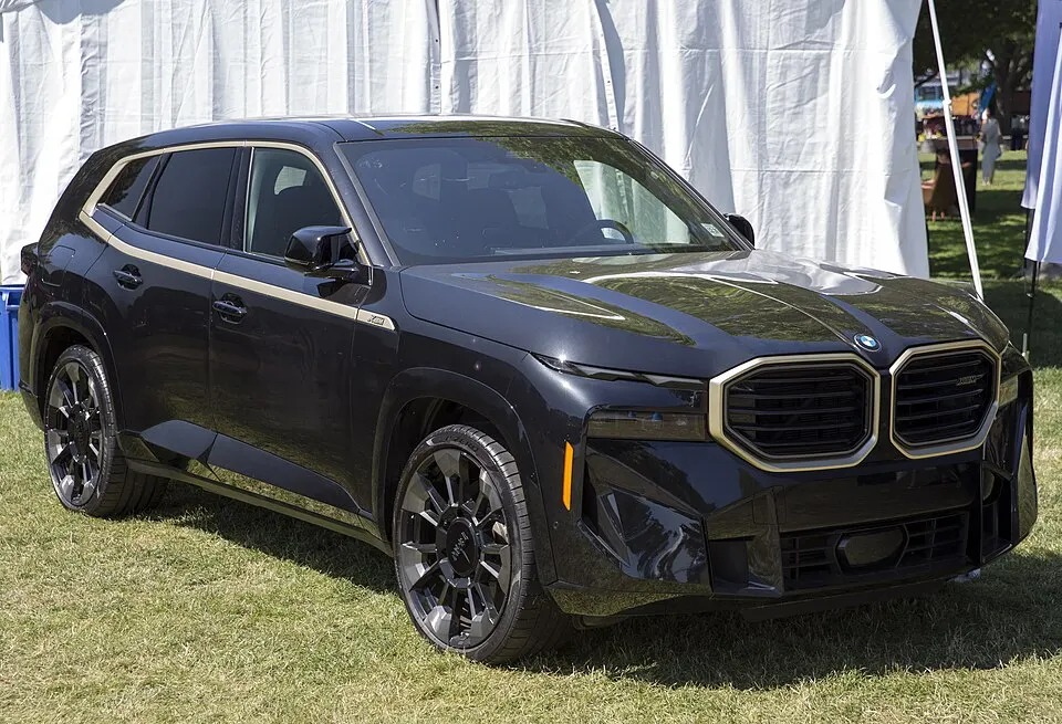 2023 BMW XM in Black Sapphire and NightGold, front right, photographed in United States
