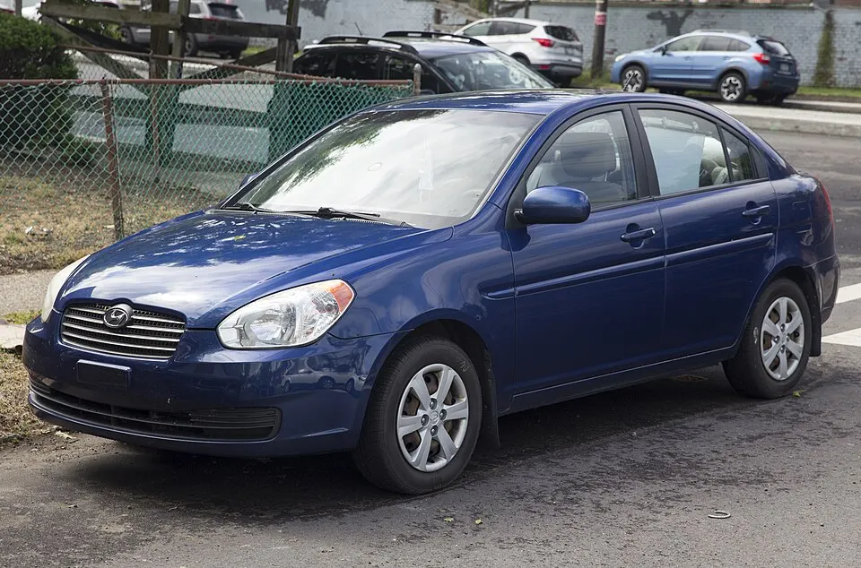 2011 Hyundai Accent GLS sedan in Dark Sapphire Blue Pearl, front left, photographed in United States