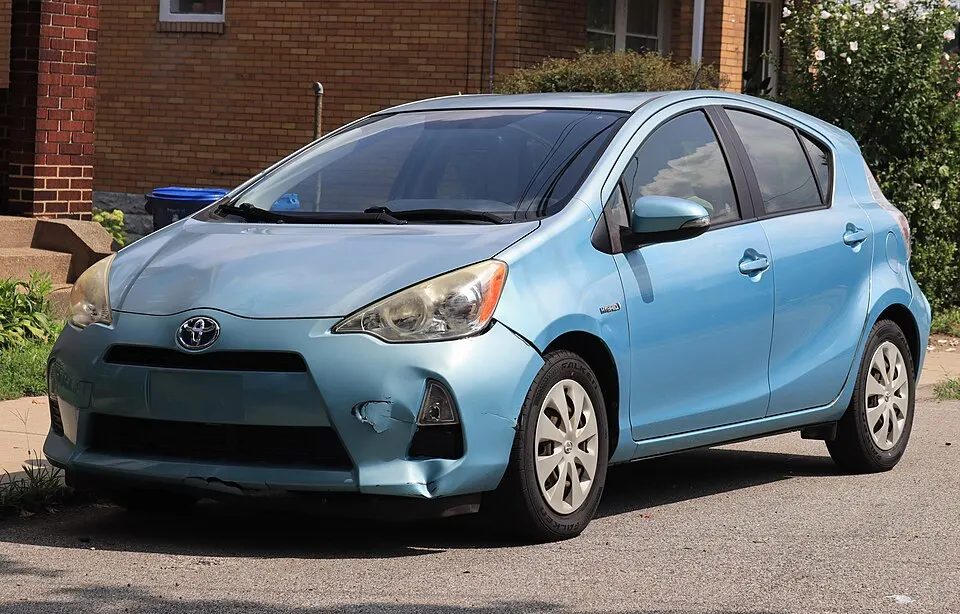 2014 Toyota Prius c One in Summer Rain Metallic, front left, 08-08-2026, photographed in United States