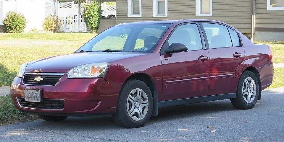 2007 Chevrolet Malibu in Sport Red Metallic, front left, 09-20-2025, photographed in United States