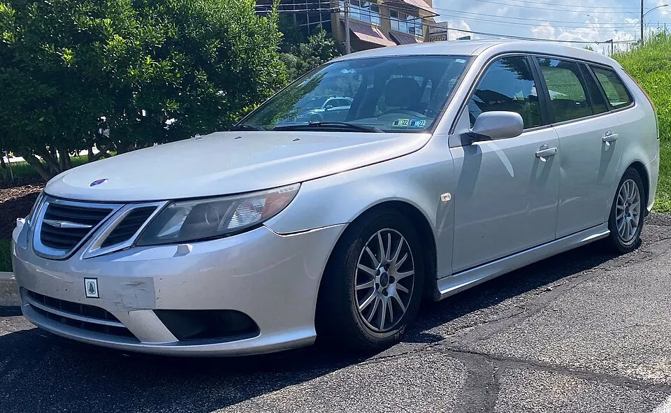 2008 Saab 9-3 2.0T SportCombi in Snow Silver Metallic, front left, 08-26-2022, photographed in United States
