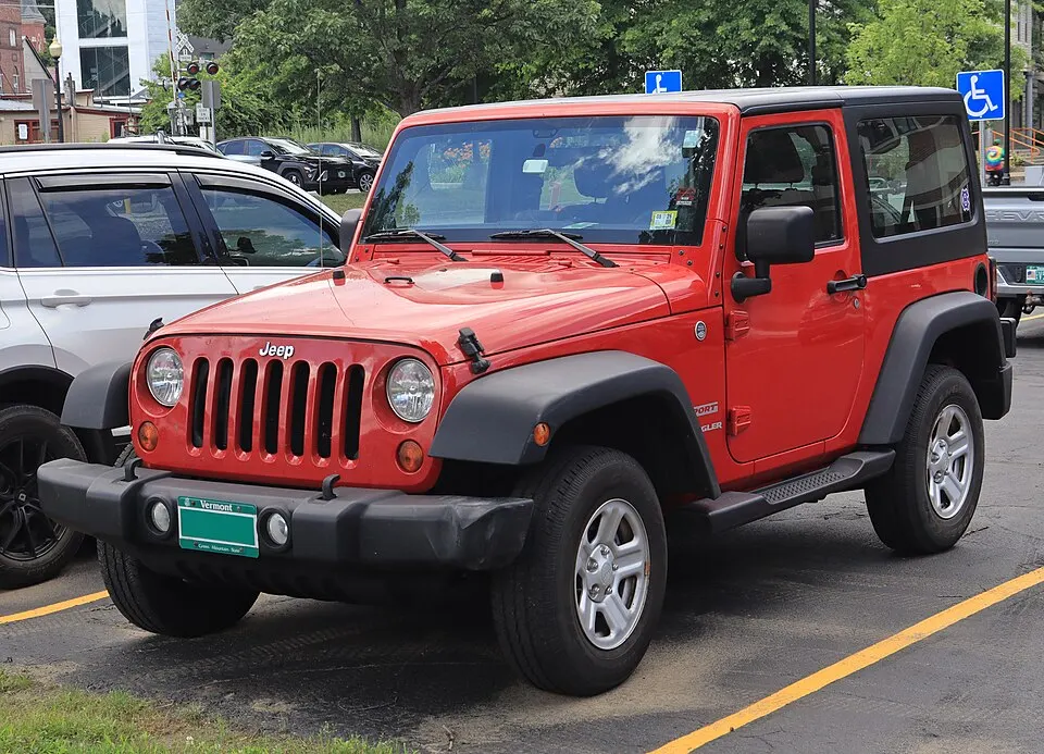 2011 Jeep Wrangler Sport in Flame Red Clearcoat, front left, 07-10-2026, photographed in United States