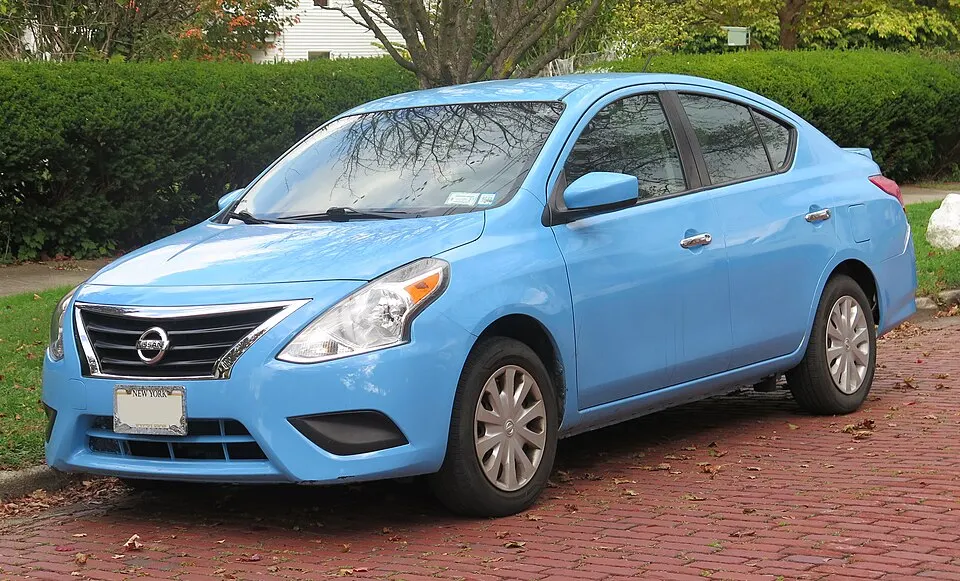 2018 Nissan Versa in cyan (resprayed), front left, 10-11-2025, photographed in United States
