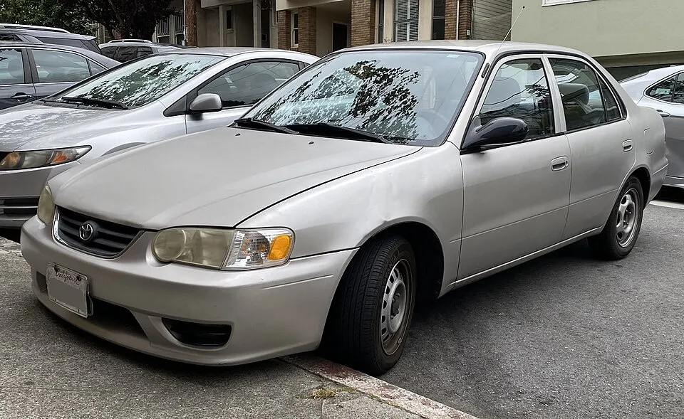 2002 Toyota Corolla LE in Sandrift Metallic, front left, 08-06-2022, photographed in United States