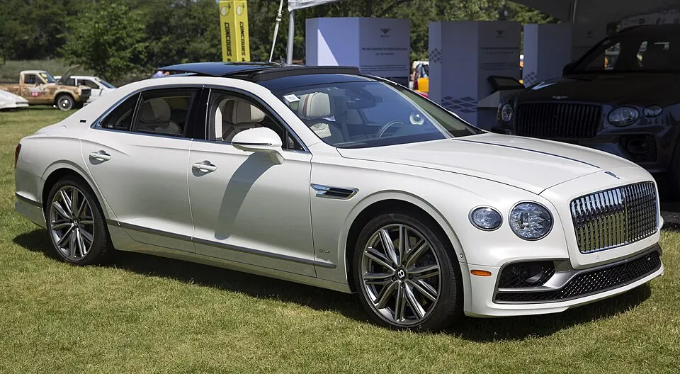 2022 Bentley Flying Spur Hybrid in Ghost White, Odyssean Specs, front right, photographed in United States